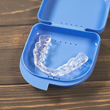 A nightguard placed inside a protective case