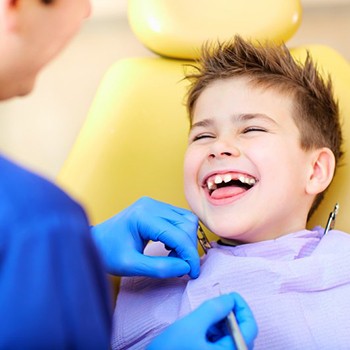 Boy smiles at his Allen children’s dentist