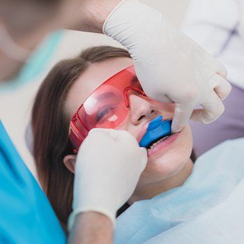 Young woman receiving fluoride treatment