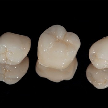 Dental crowns on a black background