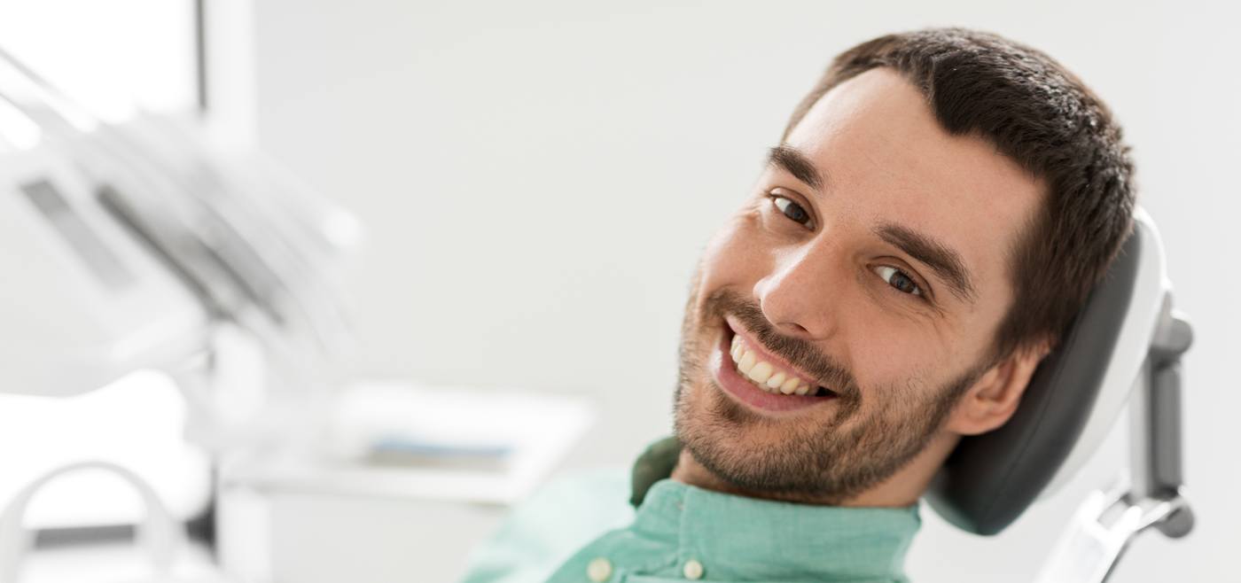 Man in dental chair smiling after emergency dentistry in Allen Texas