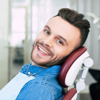 Man in dental office for preventive dentistry visit to avoid dental emergency