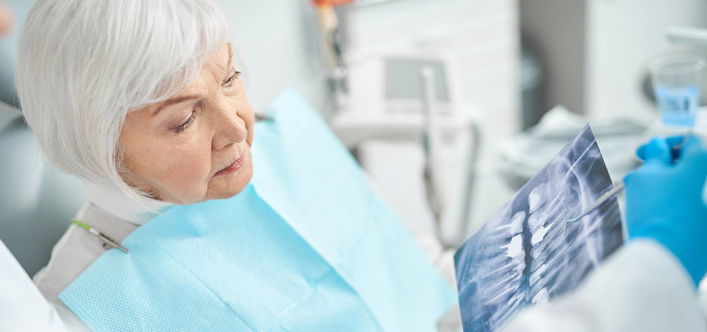 Dental patient looking at x-rays prior to tooth extraction in Allen Texas