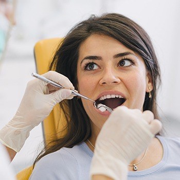 Woman having tooth extracted