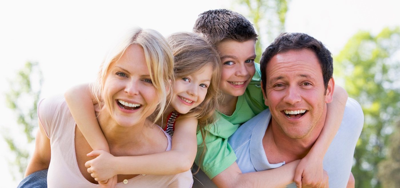 Patients smiling after seeing family dentist in Allen