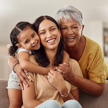 Three generations of women with healthy smiles