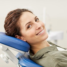 Senior woman with dental implants eating an apple