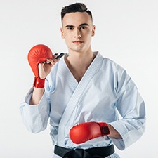 Young man using mouthguard to protect his teeth during sports