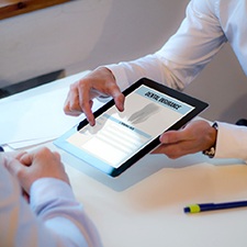 Patient reviewing dental insurance information on tablet