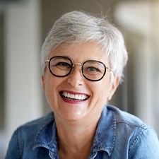 Older woman with dental implants in Allen, TX smiling