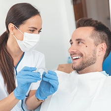 dentist explaining the cost of Invisalign in Allen to a patient 