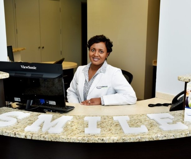 Dr. Lewis at dental office reception desk