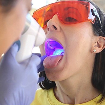 Woman receiving oral cancer screening