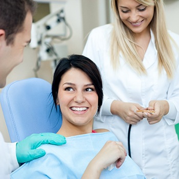 Dentist in Allen talking to female patient