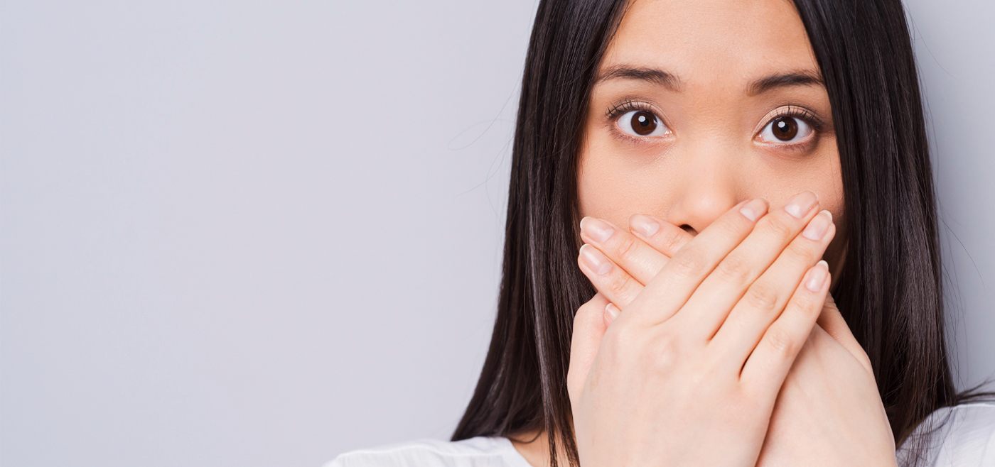 Woman fearful of dentist covering mouth needs sedation dentistry in Allen Texas