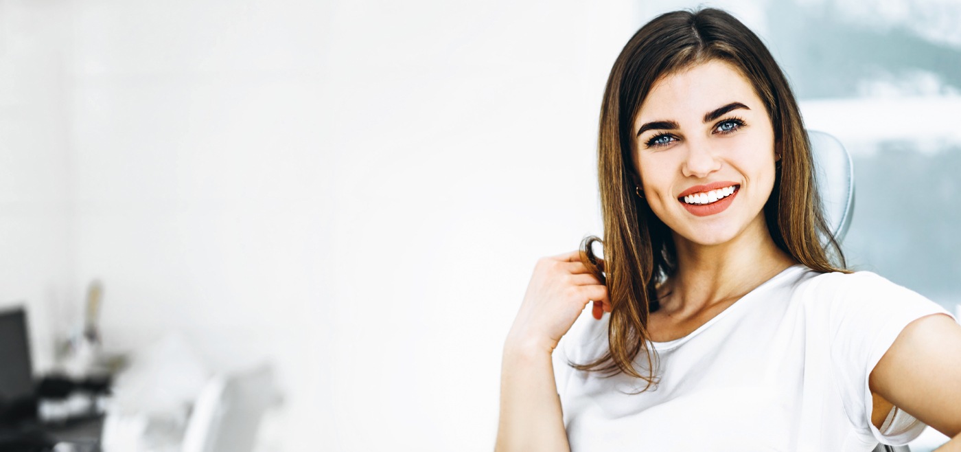 Smiling woman receiving dental services in Allen Texas