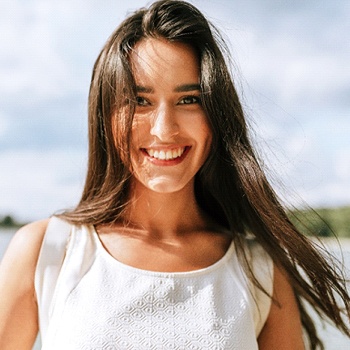 person walking on the beach and smiling