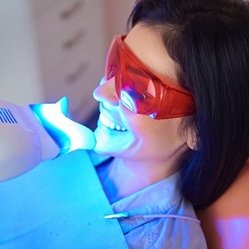 Woman smiling while getting teeth whitening in Allen