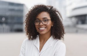 a person smiling with their arms crossed 