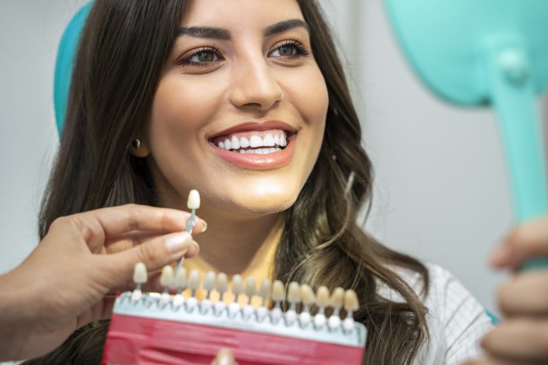 woman smiling while getting a dental crown