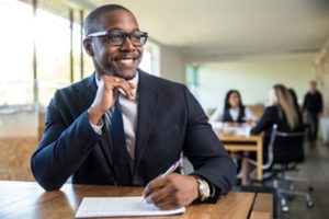 Man smiling at his office job.