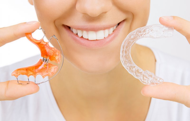 person smiling and holding retainer in Allen