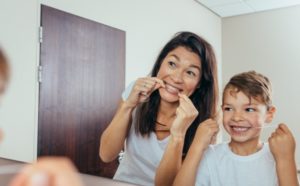 mother and child flossing