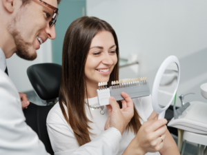 a person smiling and admiring their veneers 