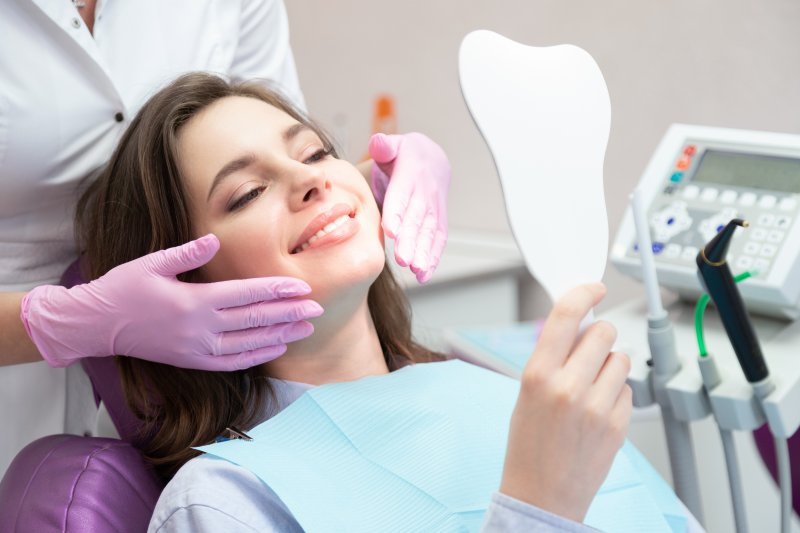 A woman smiling with her new dental veneers