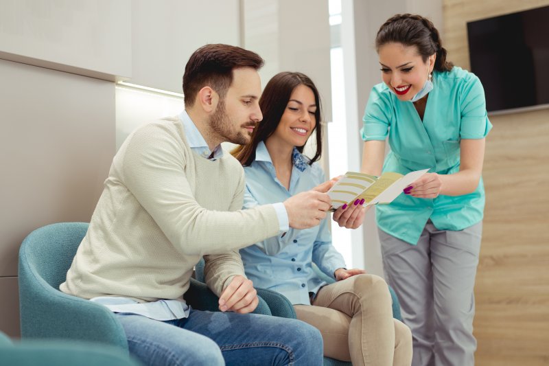 Patients talking with a dentist about dental insurance