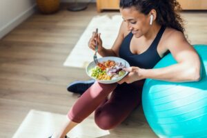 Young woman eating a salad.