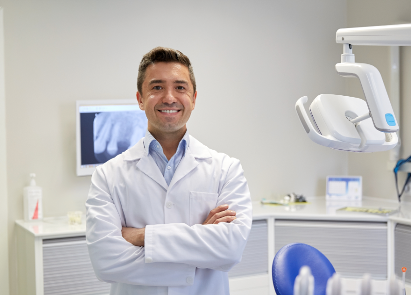 Dentist smiling with arms folded